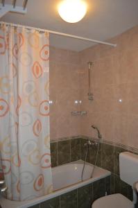 a bathroom with a tub and a shower curtain at Apartments Majstrovic in Živogošće +67 photos