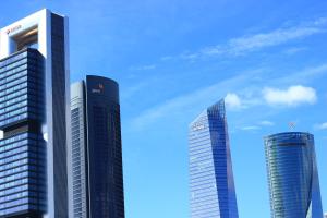 drei hohe Gebäude in einer Stadt gegen einen blauen Himmel in der Unterkunft Apartamento Calle Mauricio Legendre in Madrid