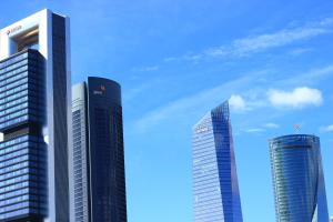 three tall buildings in a city against a blue sky at Apartamento Calle Mauricio Legendre in Madrid