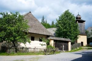 a man standing in front of a house at Penzión U Jolany in Habovka
