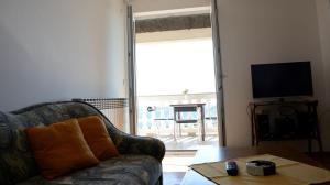 a living room with a couch and a table and a television at Apartments Dida moj in Šmrika