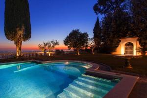 a swimming pool with a sunset in the background at Villa Gobbi Benelli in Corsanico-Bargecchia