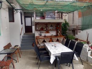 a patio with a table and chairs and a staircase at Zemunella Guest House in Herceg-Novi