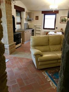 a living room with a couch and a kitchen at Residence Riccardi in San Marino