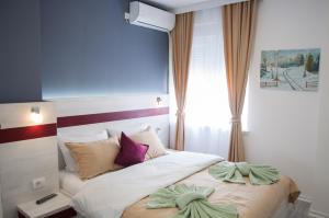 A bed or beds in a room at Apartmani Banja SPA