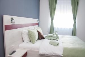 A bed or beds in a room at Apartmani Banja SPA