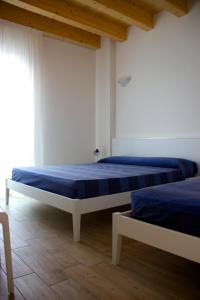 מיטה או מיטות בחדר ב-Residence la Perla