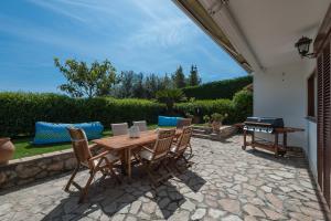a patio with a wooden table and chairs at Relais Serapo in Gaeta