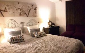 a bedroom with a large white bed with pillows at Torre Mar Apartment in Cascais