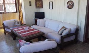a living room with a couch and a table and chairs at Alba Apartments in Banjole