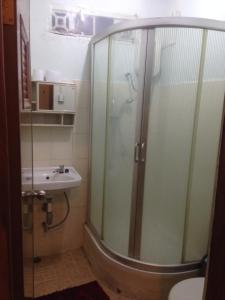 a bathroom with a shower and a sink at Vila Bemori in Dili +29 photos