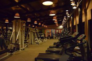 a gym with rows of tread machines and lights at Ameg Lodge Kilimanjaro in Moshi