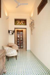 a room with a tiled floor and a door at The Ivy House in Kolkata