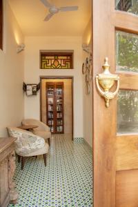 a door to a room with a table and chairs at The Ivy House in Kolkata