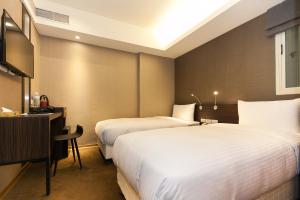 Giường trong phòng chung tại Fairytale Yi Su Hotspring Hotel