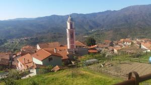 a small town with a clock tower on a hill at B&B Il Pergolo in Carro