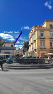 a fountain in the middle of a street with a statue at Casa Miranda in Vico Equense