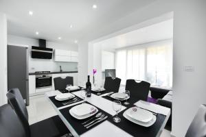 eine Küche und ein Esszimmer mit Tisch und Stühlen in der Unterkunft Apartman Kresan in Sukošan