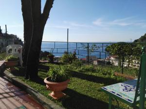a patio with a table and a view of the ocean at Casa Vacanze Bouganvillea in Cetara