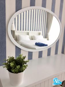 un miroir mural avec un lit et une plante dans l'établissement My Resort Hua Hin by Skystar, à Hua Hin 34 autres photos