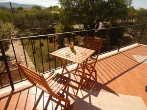 a wooden table and two chairs on a balcony at Mandić Rooms in Goriš