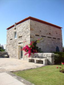 a stone building with a bench in front of it at Casa D' Joao Enes - Afife Residence in Afife