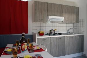 a kitchen with a table with food and drinks on it at Villaggio Camping Bosco Selva in Alberobello