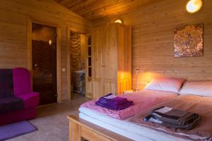 a bedroom with a large bed in a wooden room at Rojas Rodes in Roja