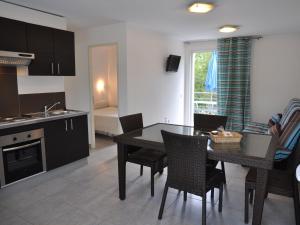 a kitchen and dining room with a table and chairs at Apartment in Moriani-Plage near the Beach in San-Nicolao