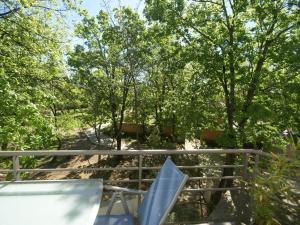a chair on a railing with trees in the background at Apartment in Moriani-Plage near the Beach in San-Nicolao