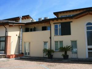 a house with two palm trees in front of it at Agriturismo with pool next 9 hole golf course and close to Sal and more in Salò