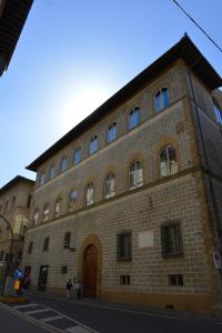 a large brick building with many windows on a street at B&B La Casa dei Tintori in Florence