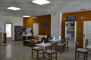 ein Restaurant mit Tischen und Stühlen in einer Bibliothek in der Unterkunft Hostal l'Esplai in Viladamat