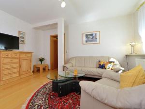 a living room with a couch and a table at Inviting Apartment in Eimelrod with Garden in Willingen