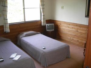 Postel nebo postele na pokoji v ubytování Pension Niimi