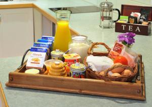 a basket of food on a counter with a bottle of orange juice at Belgrave Bed and Breakfast in Belgrave