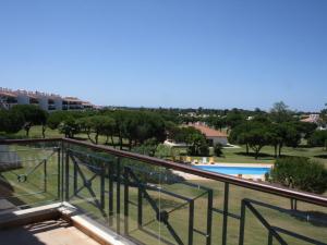 a balcony with a view of a swimming pool at Spacious Apartment in Quarteira with Swimming Pool in Vilamoura