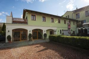 a large yellow and white building with a balcony at Penzion Valtice in Valtice