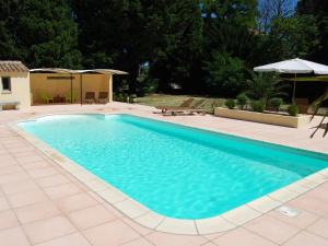 - une piscine d'eau bleue dans la cour dans l'établissement Beautiful appartment with pool in Provence, à Valréas