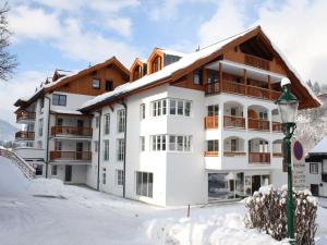 a large white building in the snow with a street light at Apartment near the ski area in Leogang in Leogang