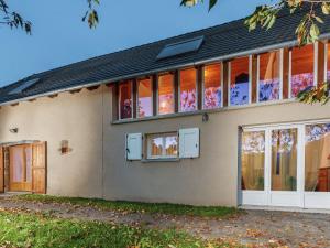 a house with a lot of windows at Former farmhouse fully renovated with garden near the Auvergne volcanoes in Calvinet