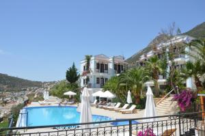 a view of a hotel with a swimming pool and buildings at The Mediteran Hotel in Kalkan