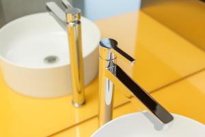 a bathroom sink with a faucet on a counter at Züri by Fassbind in Zurich