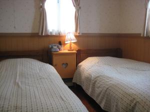 Łóżko lub łóżka w pokoju w obiekcie Pension Yumekukan