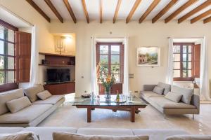 a living room with couches and a coffee table at Majestic Holiday Estate in Calvià Up to 12 Guests in Calvia Town