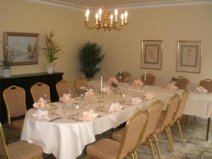 a dining room with a long table and chairs at Hotel-Restaurant Pfeffermühle in Dörverden