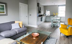 a living room with a couch and a table at Spa Apartments in Harrogate