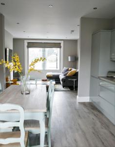 a kitchen and living room with a table and chairs at Spa Apartments in Harrogate