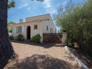 a white house with a gate and a tree at Romantic Retreat in Cargèse in Cargèse