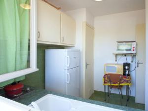 a kitchen with a white refrigerator and a microwave at Romantic Retreat in Cargèse in Cargèse +33 photos